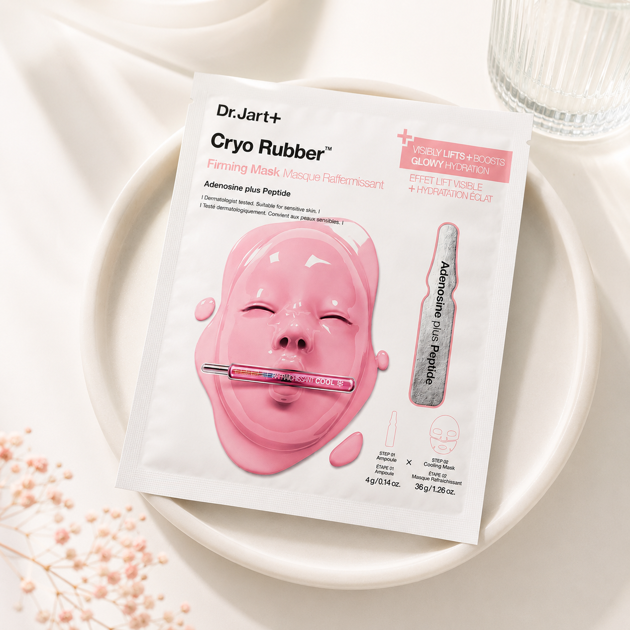 Dr.Jart+ Cryo Rubber Firming Mask with Adenosine Plus Peptide sachet elegantly displayed on a minimalist ceramic tray surrounded by soft natural light, delicate pink florals and premium spa-inspired elements, creating a luxurious skincare setting that emphasizes skin firming, elasticity, radiant hydration and a refreshing Korean beauty ritual.