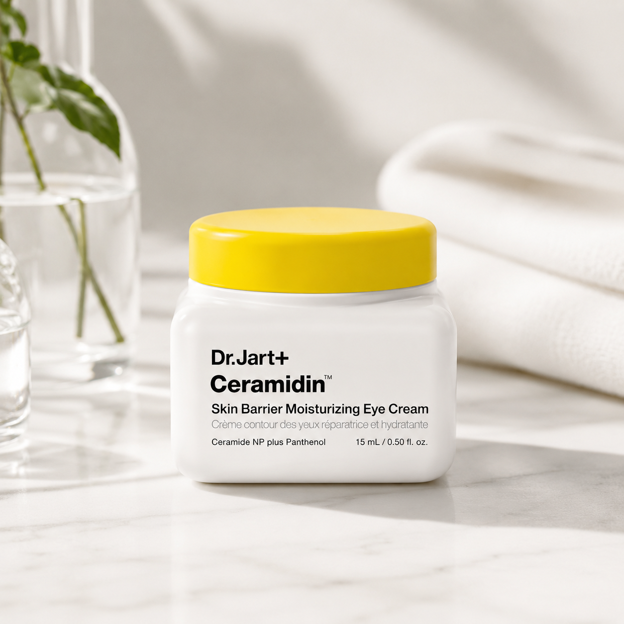 Dr.Jart+ Ceramidin Skin Barrier Moisturizing Eye Cream 15ml elegantly displayed on a marble countertop in a bright spa-inspired setting with soft towels, glass skincare accessories and gentle natural light, emphasizing intense hydration, barrier repair and daily care for the delicate eye area with a premium Korean skincare aesthetic.