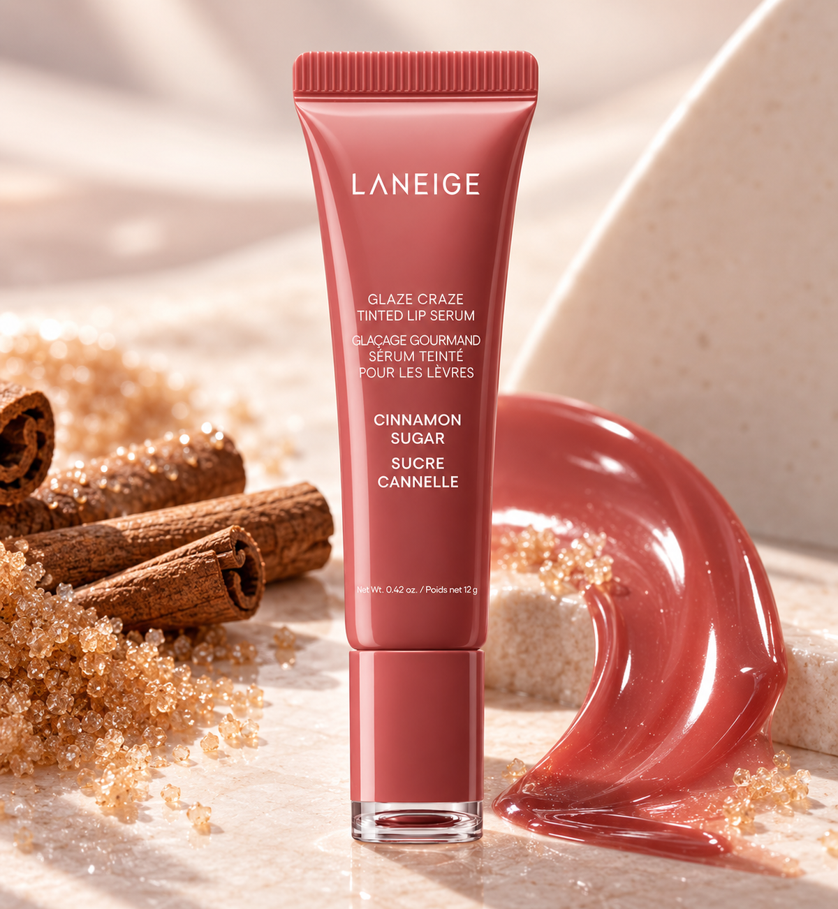 LANEIGE Glaze Craze Tinted Lip Serum Cinnamon Sugar 12g displayed with cinnamon sticks, sugar crystals and glossy tinted serum texture in a warm, elegant beauty setting.